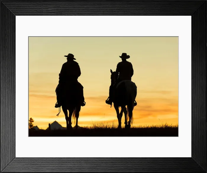 Framed Print : Two cowboys riding on horseback in a Prairie landscape at sunset Framed Print : Two cowboys riding on horseback in a Prairie landscape at sunset