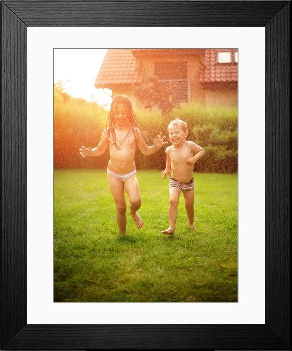 Framed Print : Joyful kids enjoying the summer shower in the garden Framed Print : Joyful kids enjoying the summer shower in the garden