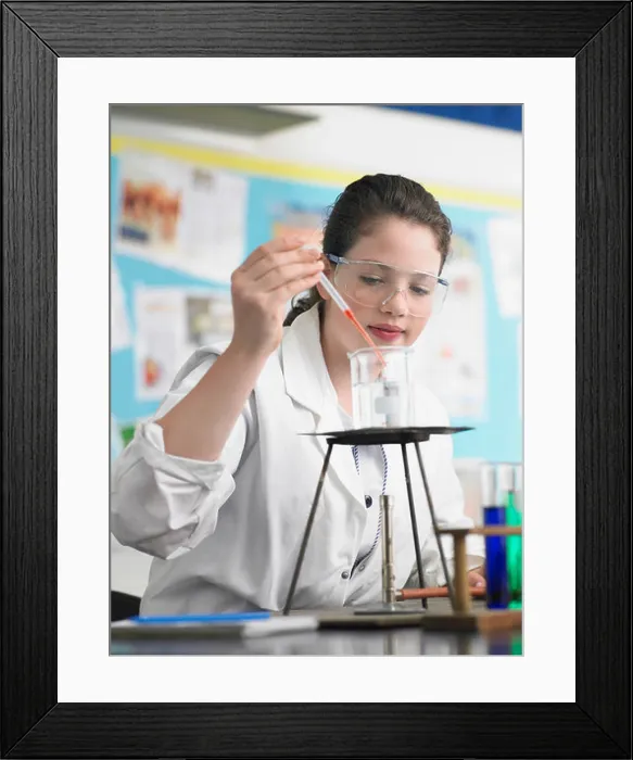 Framed Print : Teenage girl caring out experiments in chemistry class Framed Print : Teenage girl caring out experiments in chemistry class