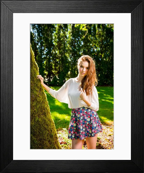 Framed Print : A beautiful young girl poses for a fashion style portrait outdoors at a park with natural lighting Framed Print : A beautiful young girl poses for a fashion style portrait outdoors at a park with natural lighting