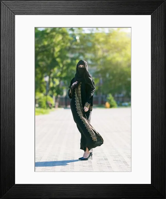 Framed Print : Muslim woman in full growth, urban lifestyle. Oriental girl in festive national dress in a European city Framed Print : Muslim woman in full growth, urban lifestyle. Oriental girl in festive national dress in a European city