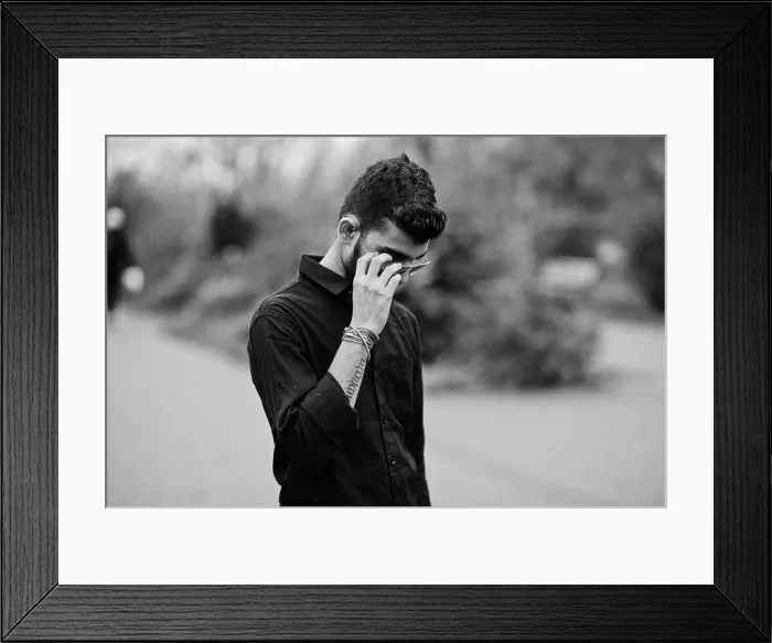 Framed Print : Indian stylish man at black shirt and sunglasses posed outdoor. Black and white photo