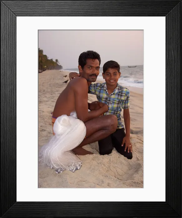 Framed Print : Young boy with his fisherman father on the beach at Kattoor Kalavoor Alappuzha Alleppey Kerala India