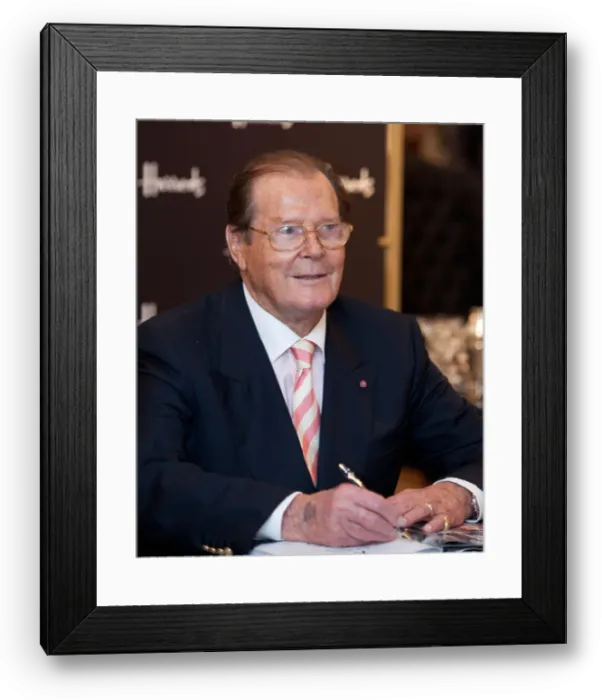 Framed Print : roger moore, actor, signs copies of his new book bond on bond at harrods store in knightsbridge, london, uk Framed Print : roger moore, actor, signs copies of his new book bond on bond at harrods store in knightsbridge, london, uk