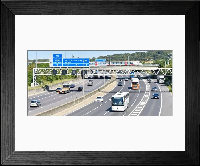 Framed Print : M25 motorway gantry signs railway bridge & Greater Anglia passenger train crossing above road traffic junction 28 for Framed Print : M25 motorway gantry signs railway bridge & Greater Anglia passenger train crossing above road traffic junction 28 for
