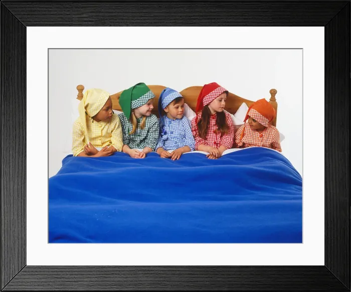 Framed Print : Five children wearing colourful, checked sleeping costumes and matching nightcaps, sitting up in a bed, front view