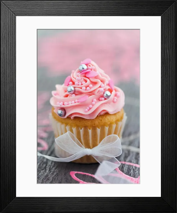 Framed Print : Pretty pink cupcake tied with an organza ribbon Framed Print : Pretty pink cupcake tied with an organza ribbon