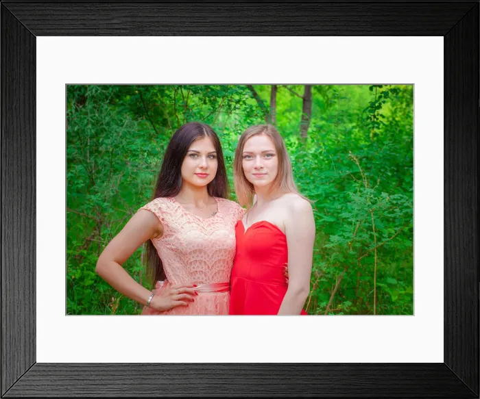 Framed Print : Joint portrait of two friends. Beautiful girls posing in beautiful dresses. Women against the backdrop of the forest Framed Print : Joint portrait of two friends. Beautiful girls posing in beautiful dresses. Women against the backdrop of the forest
