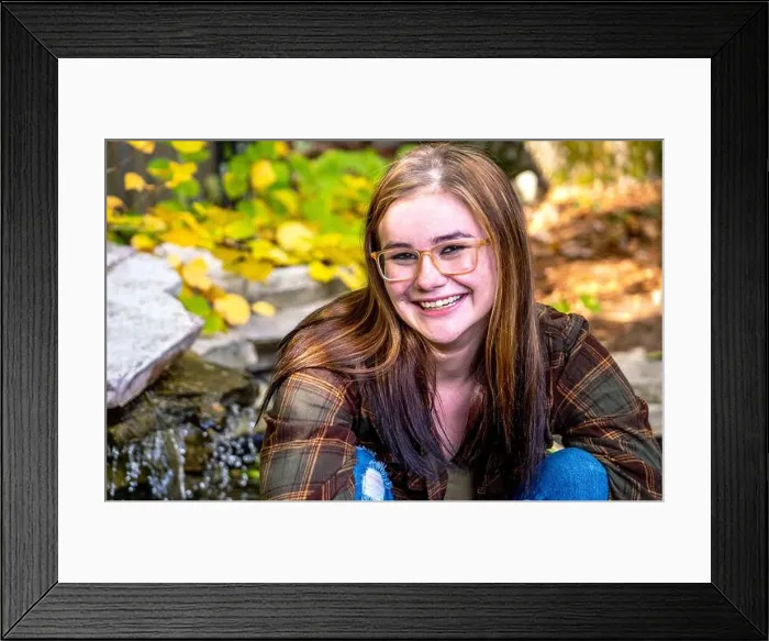 Framed Print : Happy girl poses for a senior photo in a flannel shirt and torn jeans Framed Print : Happy girl poses for a senior photo in a flannel shirt and torn jeans