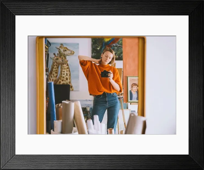 Framed Print : Reflection of woman holding camera on mirror at art studio Framed Print : Reflection of woman holding camera on mirror at art studio