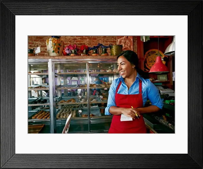 Framed Print : Hispanic waitress taking orders in bakery Framed Print : Hispanic waitress taking orders in bakery