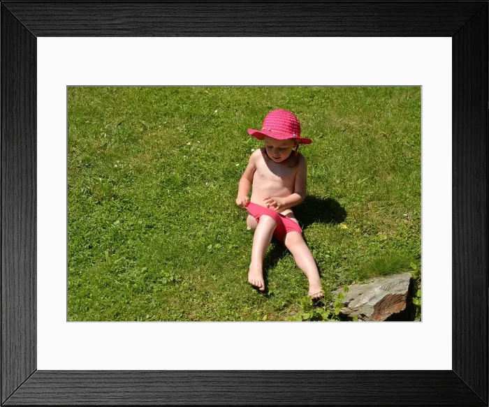 Framed Print : Wet little girl after playing with the water jet in swimsuit Framed Print : Wet little girl after playing with the water jet in swimsuit