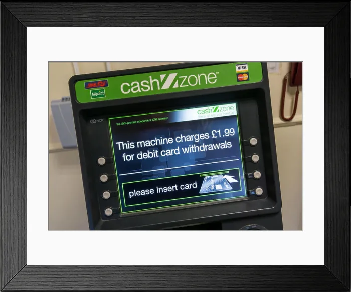 Framed Print : A CashZone ATM in a motorway service station warns that there is a £1.99 charge for cash withdrawals by debit card Framed Print : A CashZone ATM in a motorway service station warns that there is a £1.99 charge for cash withdrawals by debit card