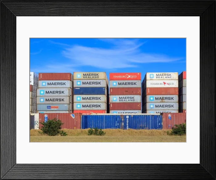 Framed Print : Stacks of shipping containers with the logos of various companies in an outdoor lot Framed Print : Stacks of shipping containers with the logos of various companies in an outdoor lot
