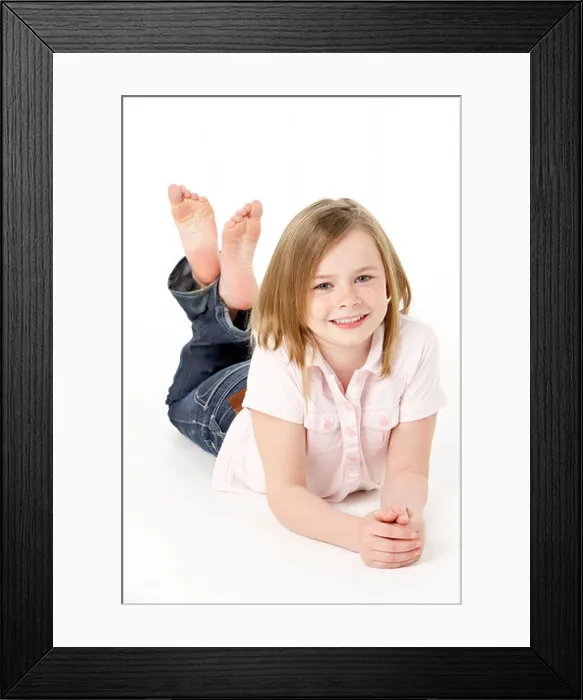Framed Print : Young Girl Lying On Stomach In Studio Framed Print : Young Girl Lying On Stomach In Studio