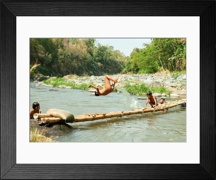 Framed Print : Residents in Taman Krocok village, Bondowoso, use the river for bathing and for playing Framed Print : Residents in Taman Krocok village, Bondowoso, use the river for bathing and for playing