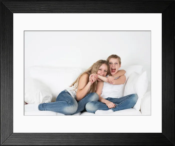 Framed Print : Girl biting a boy's hand Framed Print : Girl biting a boy's hand
