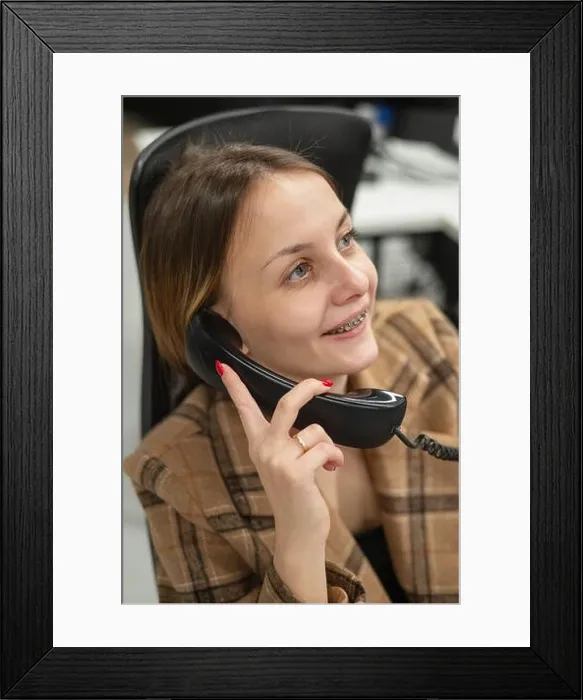 Framed Print : Business woman with braces on her teeth talking on the phone Framed Print : Business woman with braces on her teeth talking on the phone