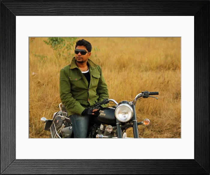 Framed Print : Young in Indian man posing by a royal enfield bullet; Bangalore India