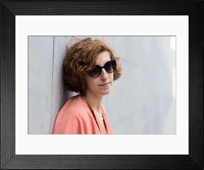 Framed Print : Portrait of a girl next door with red hair posing against a grey rough wall Framed Print : Portrait of a girl next door with red hair posing against a grey rough wall
