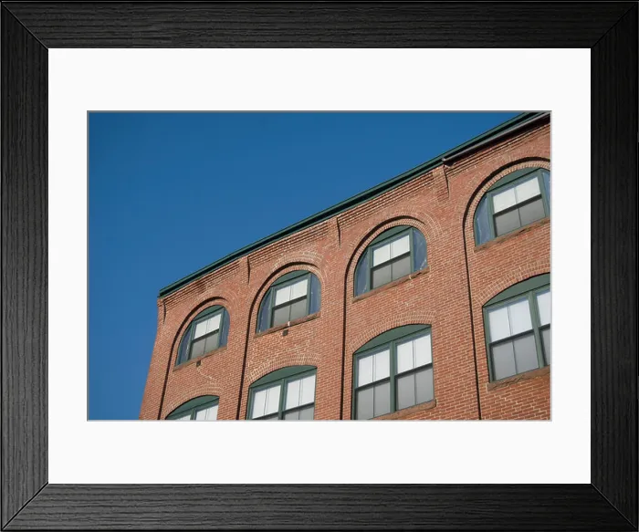 Framed Print : Arched windows in a brick warehouse wall, against a blue sky Framed Print : Arched windows in a brick warehouse wall, against a blue sky