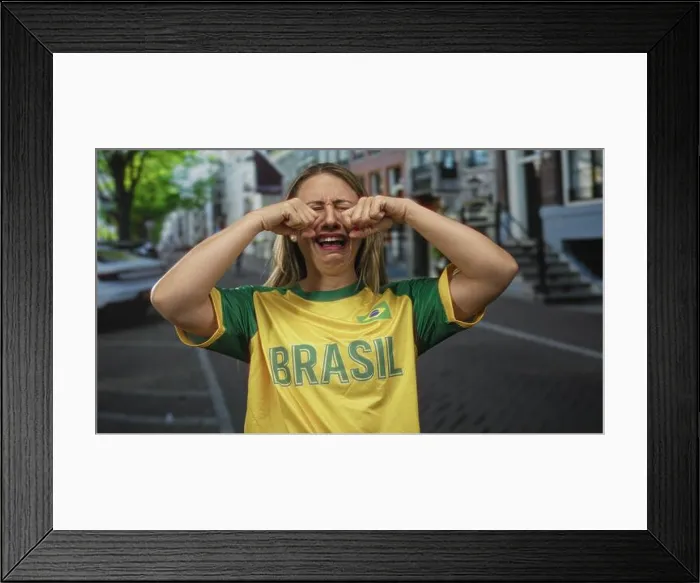 Framed Print : Woman in yellow jersey rubs fists against her eyes on street; sadness disappointment longing reflection Framed Print : Woman in yellow jersey rubs fists against her eyes on street; sadness disappointment longing reflection