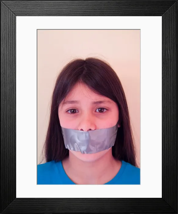 Framed Print : Young girl with tape over her mouth to illustrate suppression of freedom of speech Framed Print : Young girl with tape over her mouth to illustrate suppression of freedom of speech