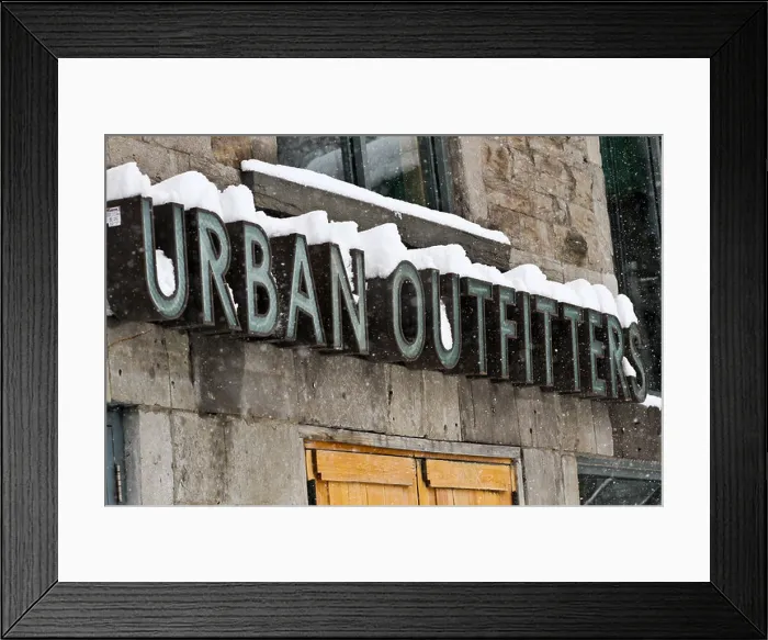 Framed Print : The Urban Outfitters sign covered in snow on St. Denis in Montreal, Quebec Framed Print : The Urban Outfitters sign covered in snow on St. Denis in Montreal, Quebec