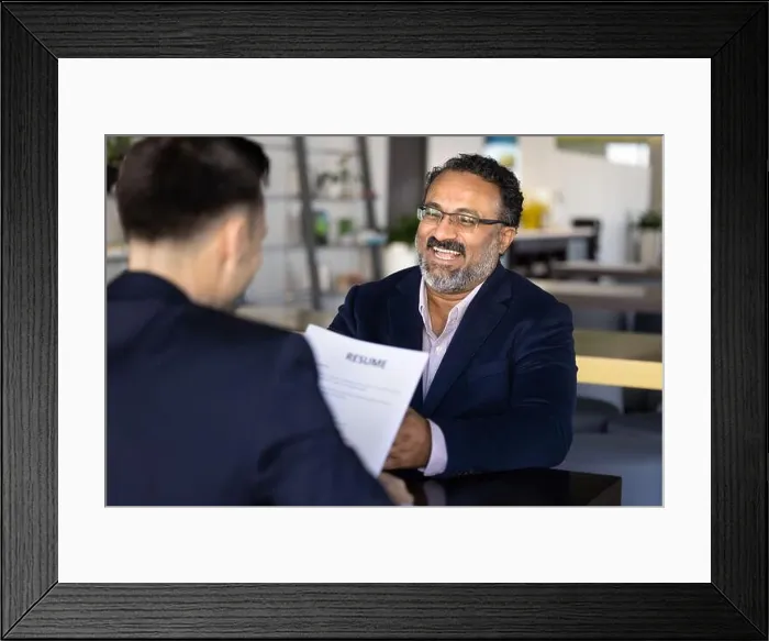 Framed Print : Laughing older Indian male applicant passing job interview successfully Framed Print : Laughing older Indian male applicant passing job interview successfully