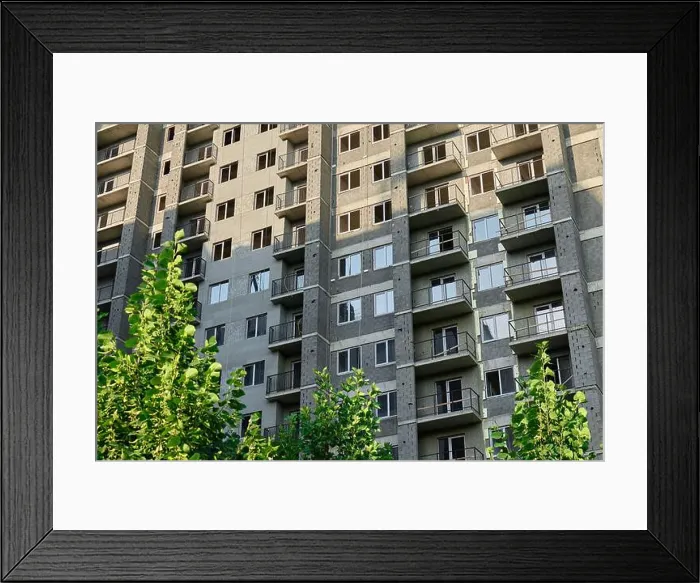 Framed Print : Modern apartment building with greenery in urban environment during daylight Framed Print : Modern apartment building with greenery in urban environment during daylight
