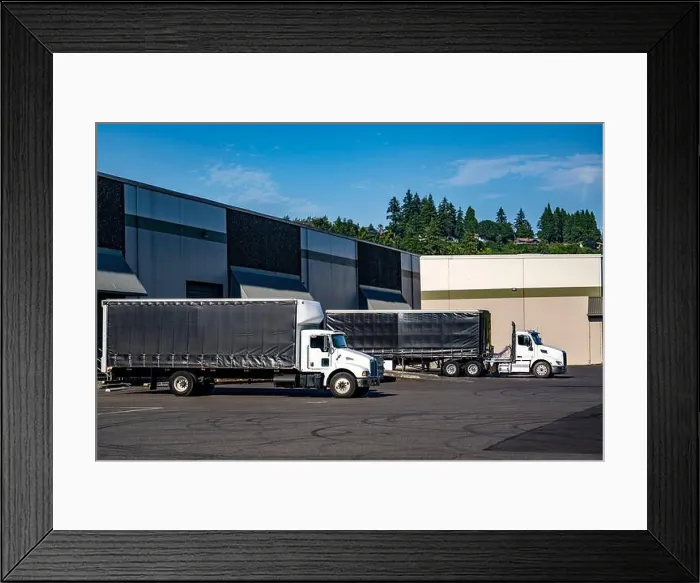 Framed Print : Industrial white day cab big rig semi trucks with conestoga flat bed semi trailer