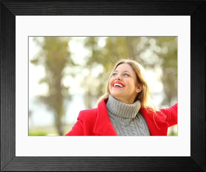 Framed Print : Portrait of a joyful candid girl wearing a red jacket and a sweater joking outdoors in a park in winter Framed Print : Portrait of a joyful candid girl wearing a red jacket and a sweater joking outdoors in a park in winter