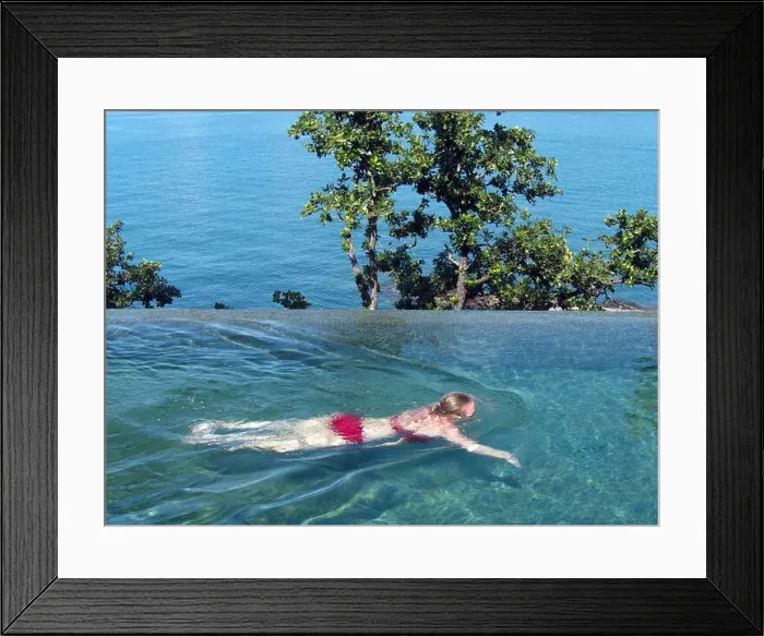 Framed Print : Young Western woman in a bikini swimming in an infinity pool at Six Senses Krabey Island, Cambodia Framed Print : Young Western woman in a bikini swimming in an infinity pool at Six Senses Krabey Island, Cambodia