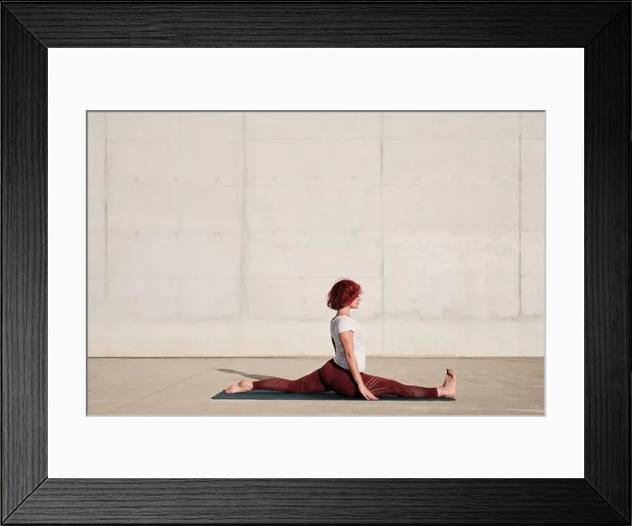 Framed Print : Side view of barefooted Woman with closed eyes in sportswear doing yoga in monkey pose on mat training alone on street Framed Print : Side view of barefooted Woman with closed eyes in sportswear doing yoga in monkey pose on mat training alone on street