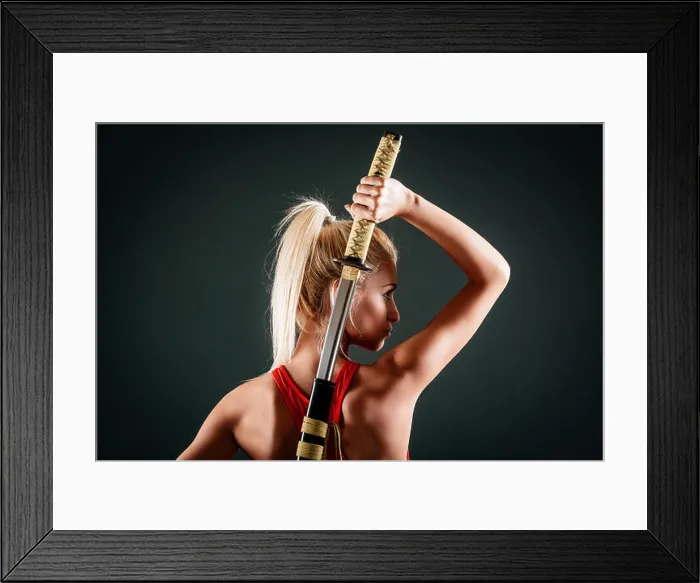 Framed Print : Rear view of beautiful young blond woman who draws a katana behind back Framed Print : Rear view of beautiful young blond woman who draws a katana behind back