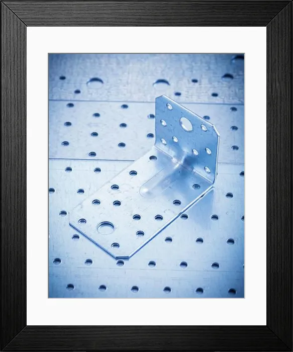 Framed Print : Stainless angle bar on perforated metallic sheet construction concept Framed Print : Stainless angle bar on perforated metallic sheet construction concept