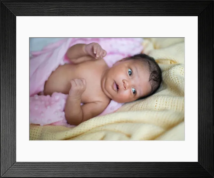 Framed Print : A beautiful newborn mixed race baby girl lying down wrapped in a pink blanket Framed Print : A beautiful newborn mixed race baby girl lying down wrapped in a pink blanket