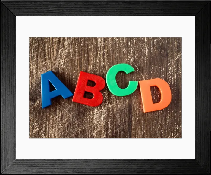 Framed Print : ABCD spelling from plastic letters on wooden background Framed Print : ABCD spelling from plastic letters on wooden background