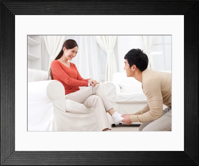 Framed Print : Husband doing foot message for his wife