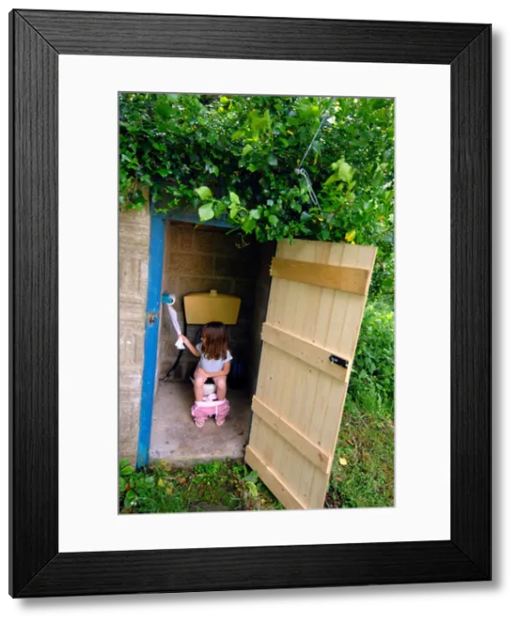 Framed Print : Toilet, Outside toilet, girl using an outdoor toilet Framed Print : Toilet, Outside toilet, girl using an outdoor toilet