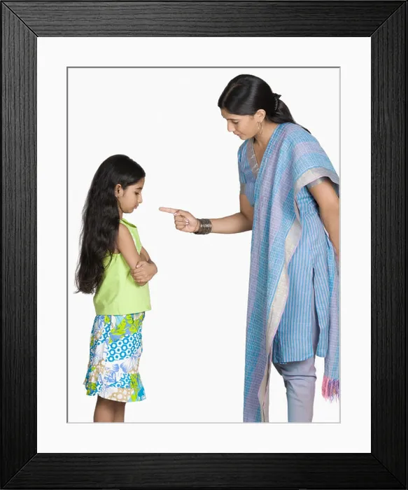 Framed Print : Side profile of a young woman scolding her daughter