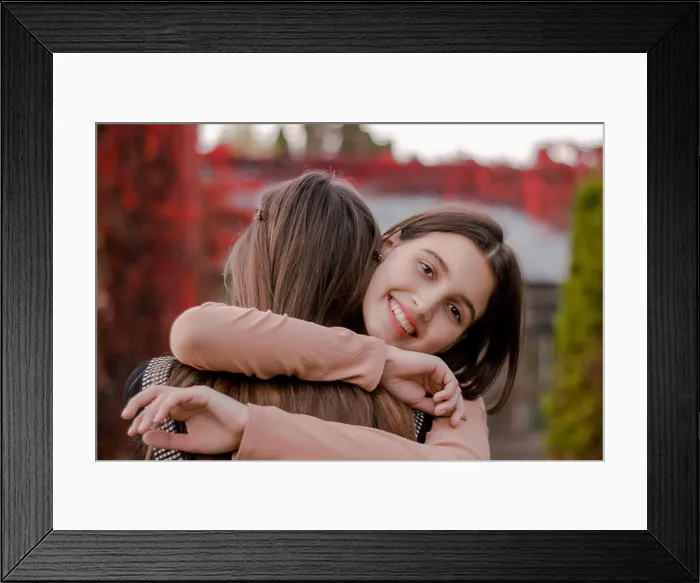 Framed Print : Smiling cute girl hugs his girlfriend tightly Framed Print : Smiling cute girl hugs his girlfriend tightly