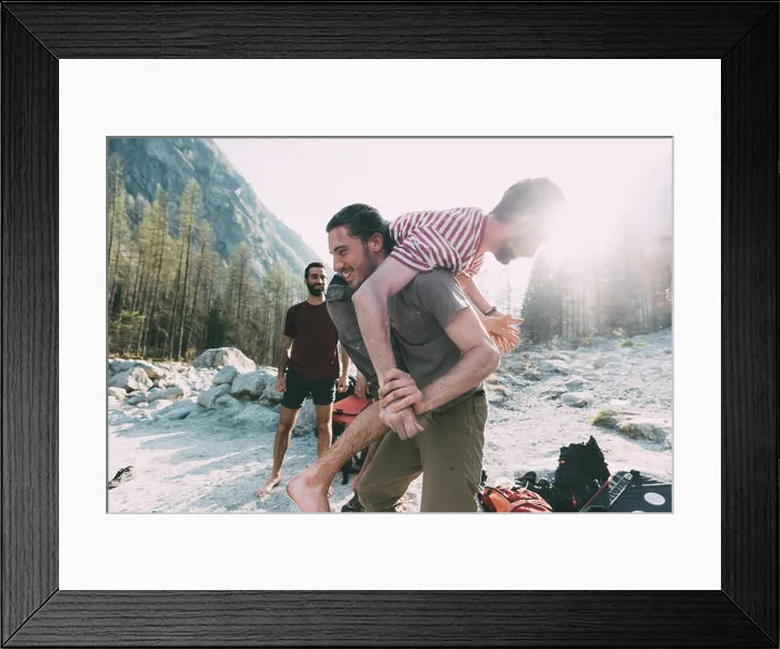 Framed Print : Young man carrying friend over shoulder on riverside, Lombardy, Italy Framed Print : Young man carrying friend over shoulder on riverside, Lombardy, Italy