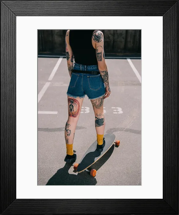 Framed Print : cropped image of stylish tattooed girl skateboarding at parking lot Framed Print : cropped image of stylish tattooed girl skateboarding at parking lot