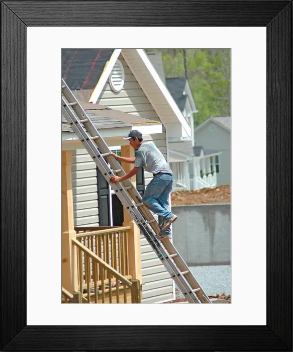 Framed Print : Roofers installing shingles on roofs outside of new home construction air nail guns with Mexican immigrants in Georgia Framed Print : Roofers installing shingles on roofs outside of new home construction air nail guns with Mexican immigrants in Georgia