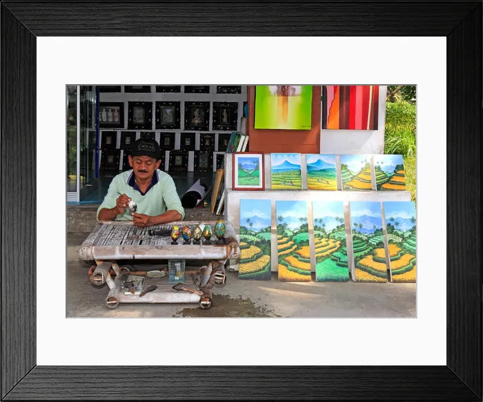 Framed Print : Artist Wayan Rana, painting eggs, outside his shop in Sebali Village, near Ubud. Bali, Indonesia. Model Released Framed Print : Artist Wayan Rana, painting eggs, outside his shop in Sebali Village, near Ubud. Bali, Indonesia. Model Released