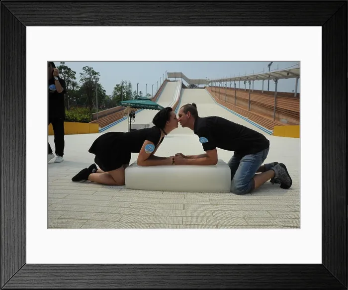Framed Print : A couple of lovers leaning on an ice block kiss each other during a kissing competition at a scenic spot during a Framed Print : A couple of lovers leaning on an ice block kiss each other during a kissing competition at a scenic spot during a