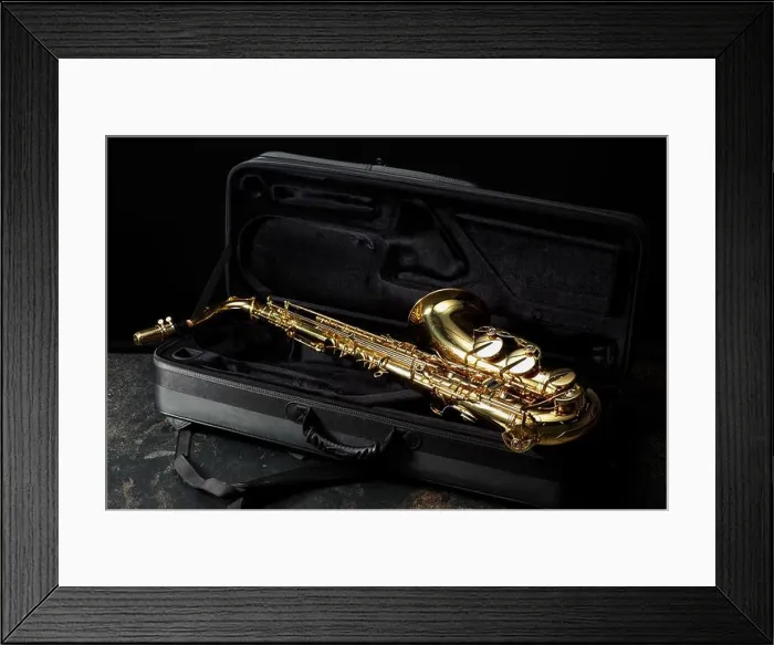 Framed Print : Jazz. Golden saxophone in case on black textured table Framed Print : Jazz. Golden saxophone in case on black textured table