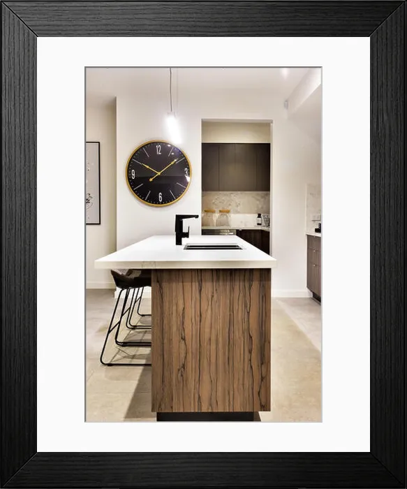 Framed Print : Modern kitchen countertop made in wood with a wall watch and chairs of a luxury house Framed Print : Modern kitchen countertop made in wood with a wall watch and chairs of a luxury house