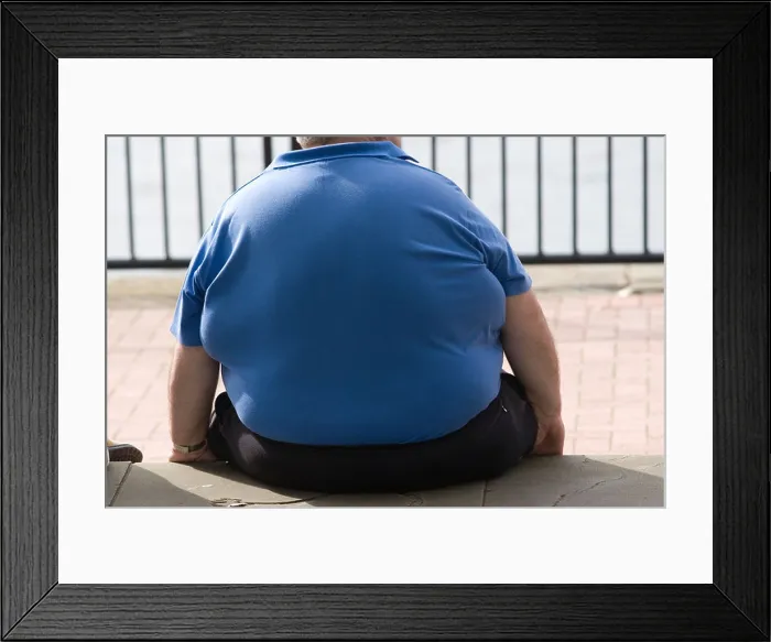 Framed Print : Obese man sitting on wall, Cardiif, Wales, UK Framed Print : Obese man sitting on wall, Cardiif, Wales, UK